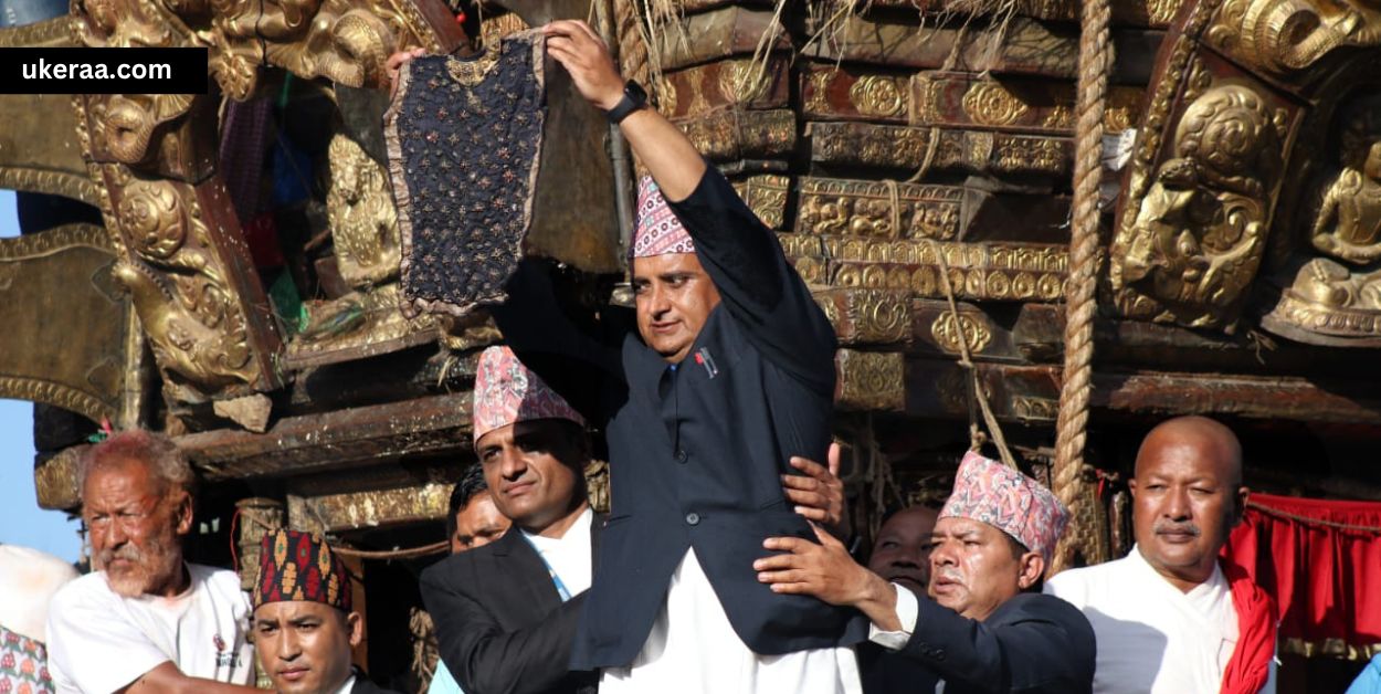 A representative from Guthi Sansthan displaying the bhoto during the festival.