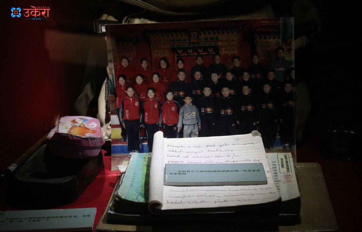 A book, picture, and tiffin box found in the earthquake rubble, displayed in the museum.