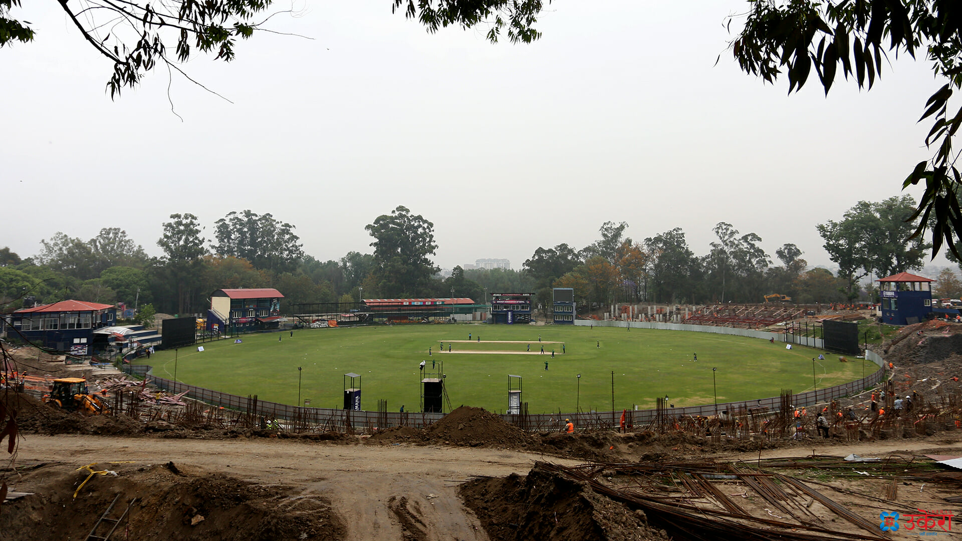 निर्माणाधीन त्रिवि क्रिकेट रंगशालाको मैदानमा भइरहेको क्रिकेट खेल।